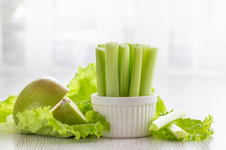 Vegetarian healthy food concept. Green celery, lettuce leaves and aplle.の写真素材