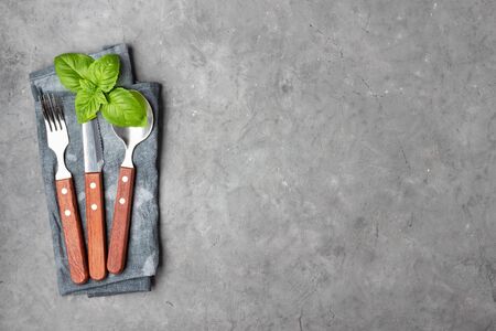 Set of cutlery knife, spoon and fork over gray concrete background. Concept menu restaurant.の写真素材