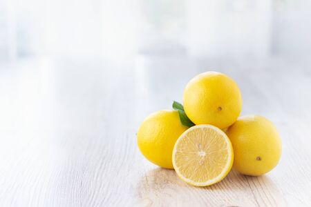 Fresh lemons on bright kitchen table. Copy space for text.の写真素材