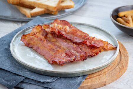 Crispy fried bacon on a plate.の写真素材