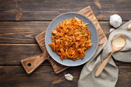 Stewed or braised cabbage in a plate on a wooden table.