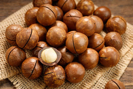 Macadamia nuts on a wooden table.の写真素材