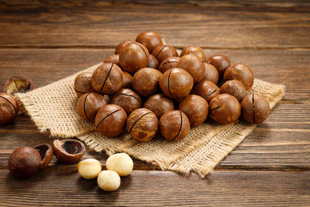 Macadamia nuts on a wooden table.の写真素材