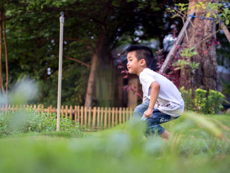 Chinese Child (boy) Crouch on The Park