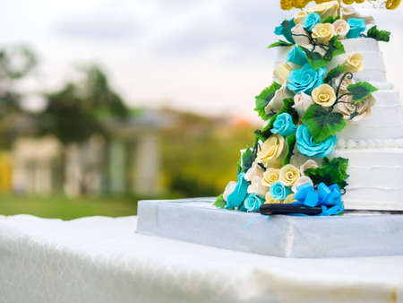 Beautiful wedding cake with blue and yellow roses