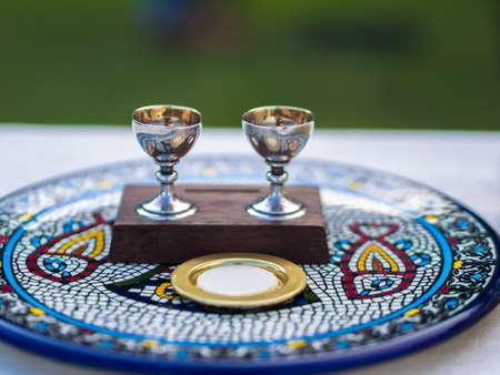 Wine and Host (Sacramental Bread) on Ceramic Plateの写真素材