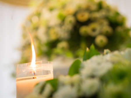Candle Burning with Flower Backgroundの写真素材