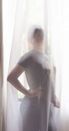 Chinese Girl Standing in Front of Windowの写真素材