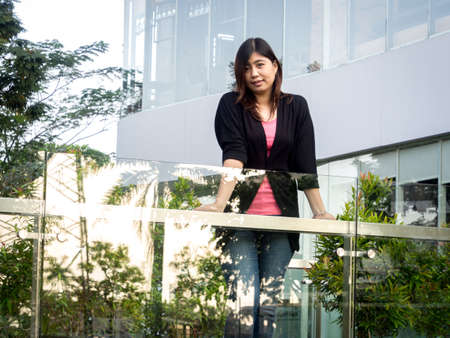 Beautiful Young Asian - Chinese Woman Smiling on Terrace