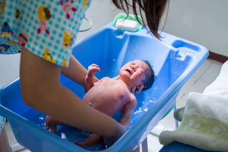Mother Bathing Her Babyの写真素材