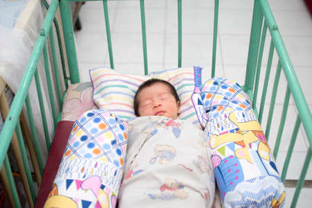 Close Up of Asian Baby Sleeping in Trellis