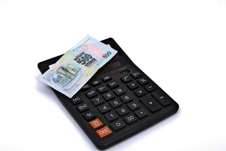 calculator and currency on white backgroundの写真素材