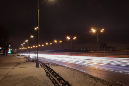 Night traffic on the road in winter. Lights of cars on the road.の写真素材