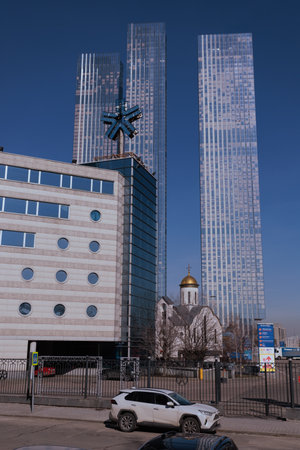 Orthodox Church of St. Seraphim of Sarov against the backdrop of modern skyscrapersの写真素材