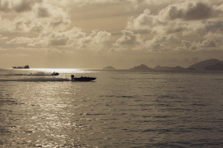 Fishing boat in the sea at sunset. vintage color tone.の写真素材