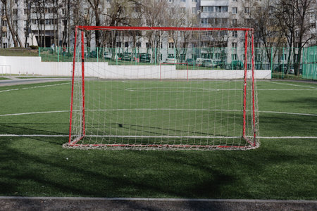 Soccer goal on a green artificial turf in a football stadium.の写真素材