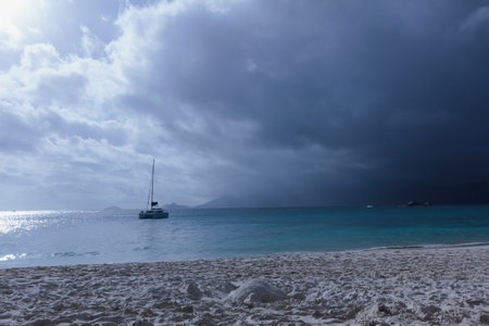 Sailing boat in the sea on the background of the stormy skyの写真素材