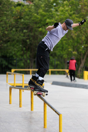 Roller skating exercises, skater performs various exercises in the skate park