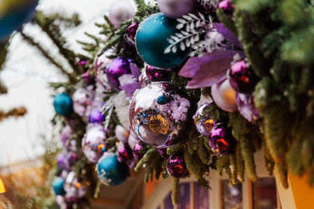 Christmas tree decorated with colorful balls and ribbons, close-upの写真素材