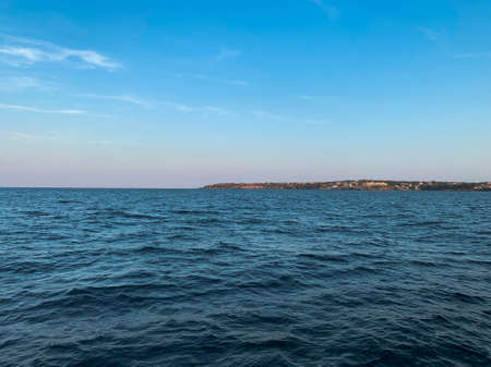 Seascape with wide and calm waters at sunsetの写真素材