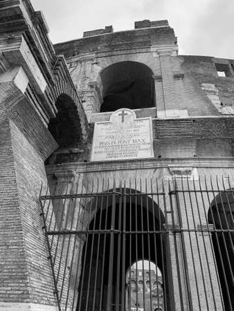 Black and white photo low-angle close up view of west outer wall exterior section of the Colosseum with a Latin historical inscription plate, Colosseo, Rome, Italy,のeditorial素材