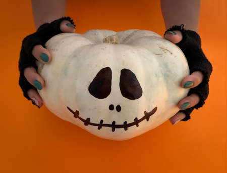 Spooky hands holding Halloween jack o lantern pumpkinの写真素材