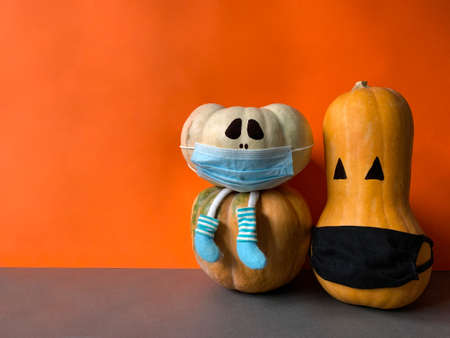 Creepy Halloween pumpkins with face masks in Coronavirus pandemicの写真素材
