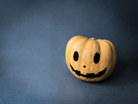 Halloween pumpkin head jack lantern on dark background with copy spaceの写真素材
