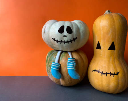 Halloween party decoration pumpkins over orange background with copy spaceの写真素材