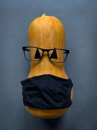 Top view of pumpkin character with glasses and face protective maskの写真素材