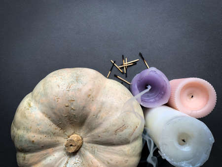Festive autumn background for Halloween / Thanksgiving with pumpkin and extinguished candles. Top view, copy space.の写真素材