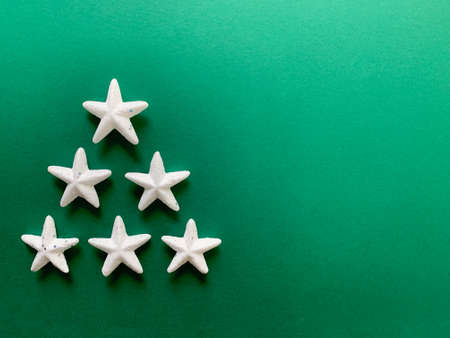 Flat lay abstract Christmas and New Year's holiday background with copy space. White snowflake stars...