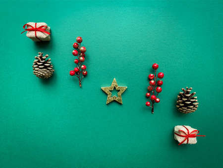 Top view composition with Christmas star,  festive decor and gift box on green backgroundの写真素材