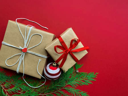 Christmas presents isolated on red background with Christmas decoration. Flat lay. Copy space.の写真素材