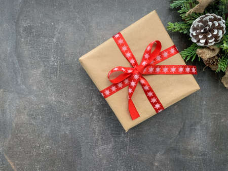 Minimal Christmas background concept with present and winter tree decoration. Flat lay with copy space.の写真素材