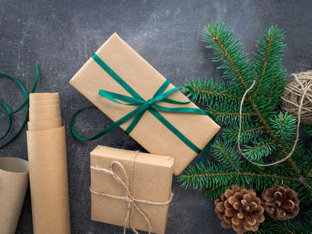 Hand crafted gifts on dark rustic wooden background with Christmas winter decorations.の写真素材