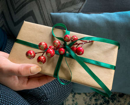Woman's hands hold elegant decorated gift box. Merry Christmas concept. Happy New Year. Happy holidays.の写真素材
