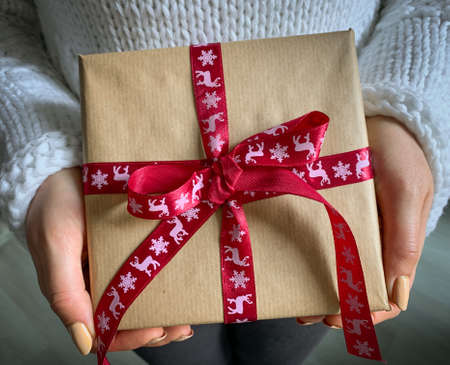 Wrapped vintage gift box. Christmas present in hands. Close up view.の写真素材