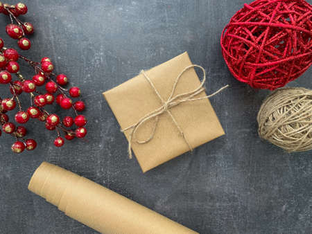 Simple gift box wrapped in craft paper on wooden background.の写真素材