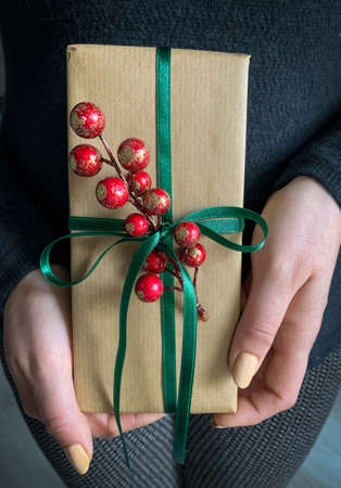 Hands of woman holding holiday present.の写真素材