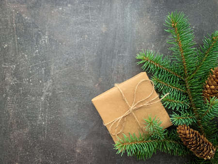 Christmas background with fir tree, pine cones and handmade gift box. Top view with copy spaceの写真素材
