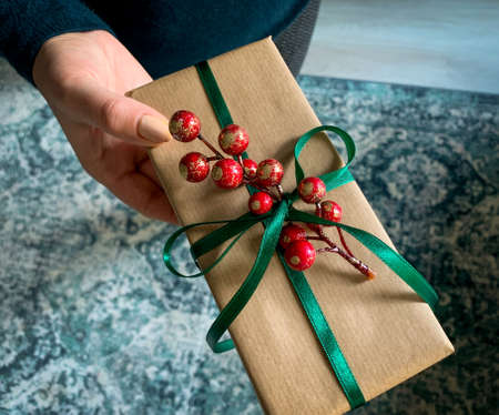 Giving a present gift box for a special day. Happy holiday background.の写真素材