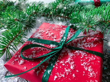 Christmas present on snow. Greeting card Merry Christmas and Happy New Year.の写真素材