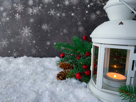 White lantern glowing on a snowy christmas night. Festive snowy mood glittering background.の写真素材