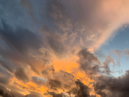 Burning sunset. A beautiful dramatic light behind evening clouds.の写真素材