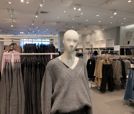 Close up view of a fashion mannequin inside modern women's clothing store.の写真素材