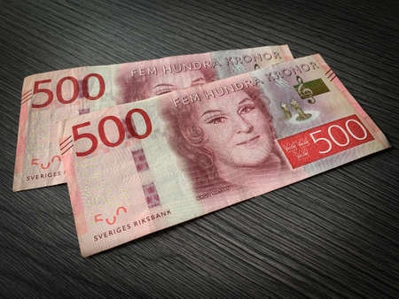 Swedish krone bills isolated on dark wooden background. Close up 500 fem hundra kronor.の写真素材