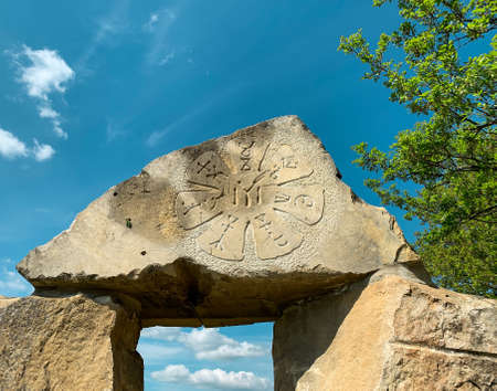 Pliska rosette engraved on megalith rock in Bulgarian Stonehenge. Modern stone cromlech in village of Rayuvtsi, Bulgaria.の写真素材