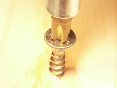 screw srewing up in woodの写真素材