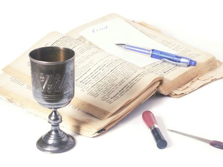 An oldcooking book and a glass of wineの写真素材